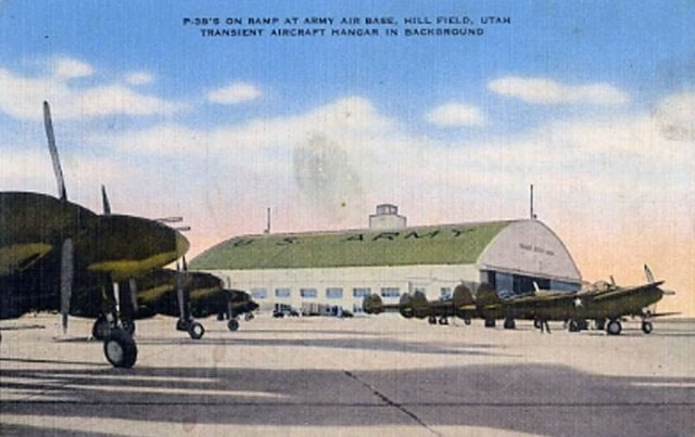 P-38 fighters on the ramp at Hill Field Army Air Base ... transient aircraft hangar in the background